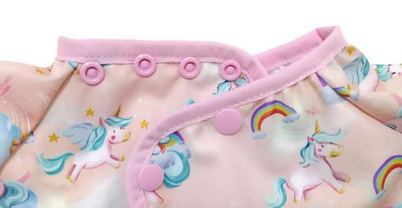 Long sleeved bib, waterproof, with built-in pocket bag Unicorns